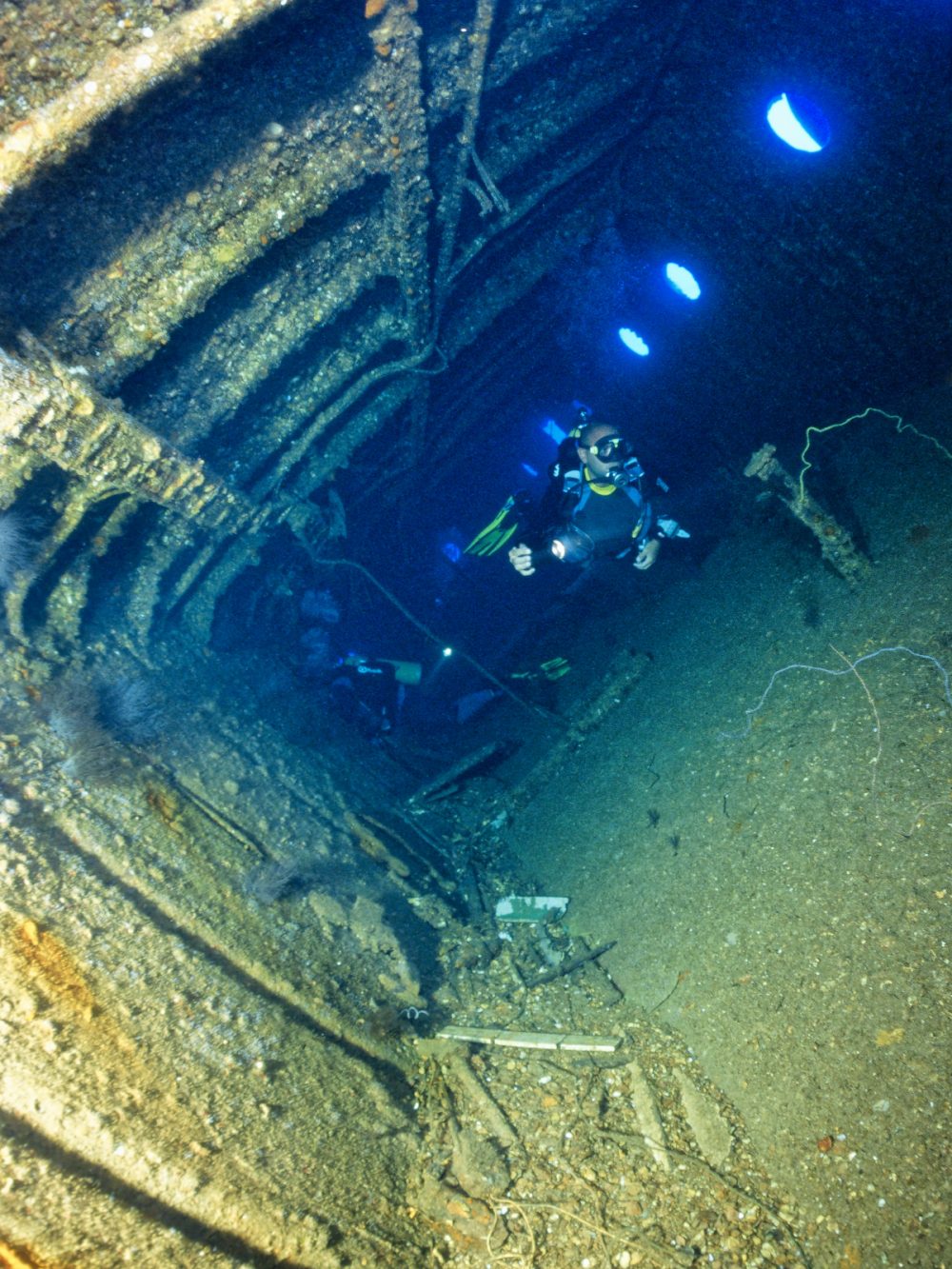 EGYPT, Red Sea, scuba divers inside the wreck of a sunken ship